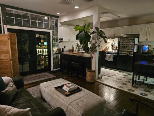 a living room with a couch and a kitchen at Tranquility at the House of Alchemy Hollywood in Los Angeles