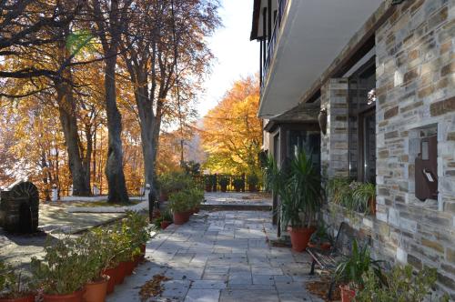 a stone walkway next to a building with plants at Hotel Hani Zisi in Chania