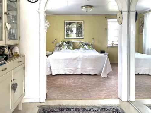 a bedroom with a bed with a white bedspread at 4 star holiday home in UDDEVALLA in Uddevalla