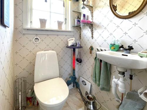 a bathroom with a toilet and a sink at 4 star holiday home in UDDEVALLA in Uddevalla