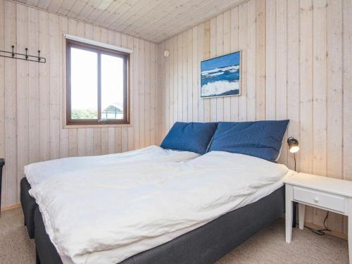a bedroom with a large bed and a window at 4 star holiday home in Juelsminde-By Traum in Sønderby