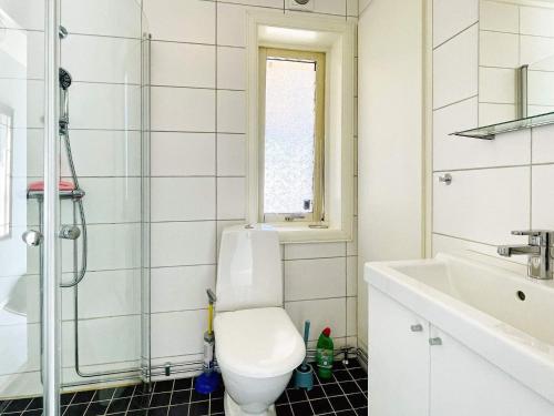 a bathroom with a toilet and a sink at 4 person holiday home in DALS ROSTOCK in Dals Rostock