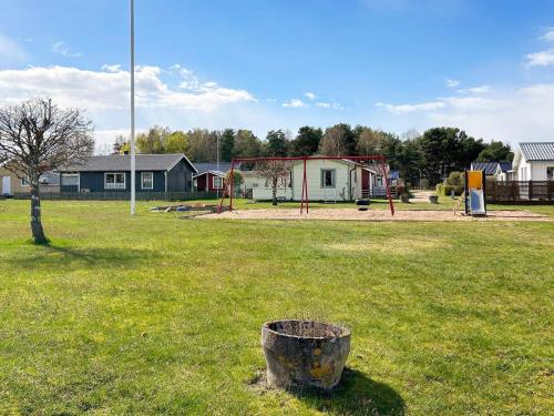 a park with a playground and a tree in the grass at Beautiful holiday home near sea-By Traum in Laholm