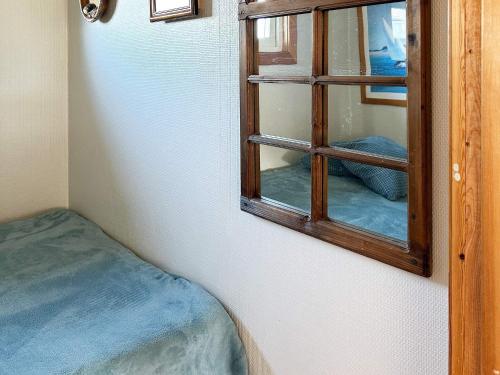 a mirror hanging on a wall next to a room at Beautiful holiday home near sea-By Traum in Laholm