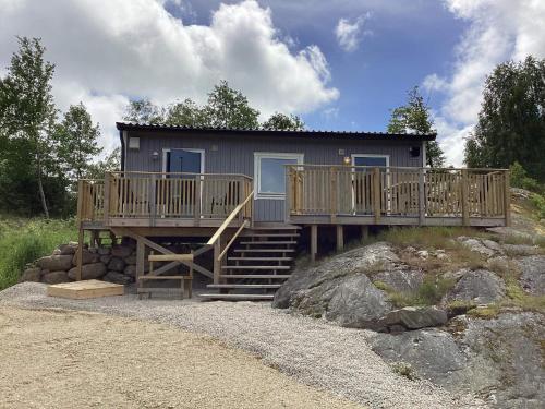 a house with wooden decks on a rock at 4 person holiday home in Nösund in Nösund