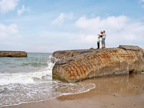 a couple standing on a rock on the beach at 12 person holiday park home in Hanstholm in Hanstholm