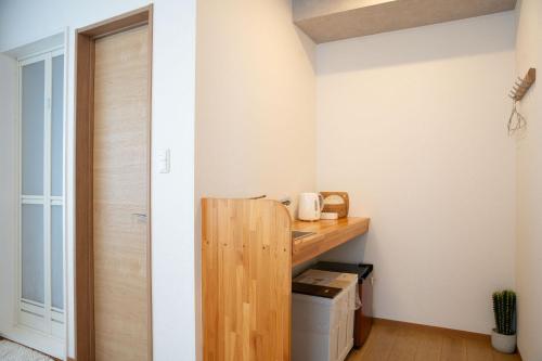a room with a wooden shelf and a door at Upper Hotel Ishihara in Tokyo