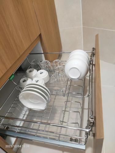 a shelf in a kitchen with plates and bowls at The ocean city view in Kota Kinabalu