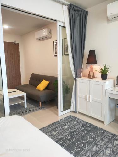 a room with a bed and a couch and a table at The ocean city view in Kota Kinabalu