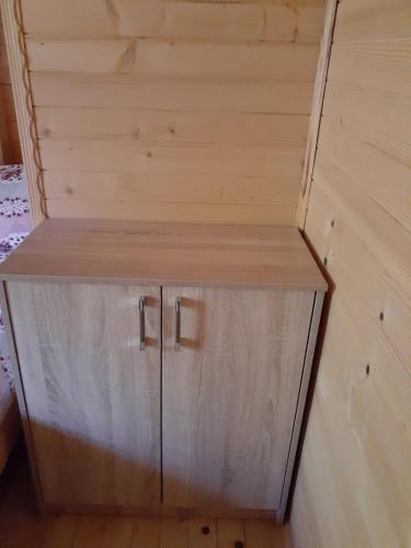 a wooden cabinet in the corner of a room at Prokletije Vucetic sobe in Dolja