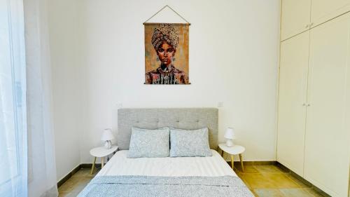 a bedroom with a bed and a painting on the wall at Villa Anastasia ,150 m to Coral Bay beach in Peyia