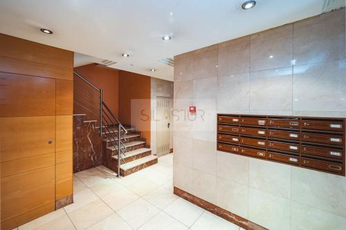 a large room with a staircase and a walk in closet at El Bosque Del Puerto in Gijón