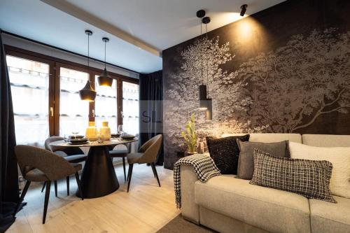 a living room with a couch and a table at El Bosque Del Puerto in Gijón