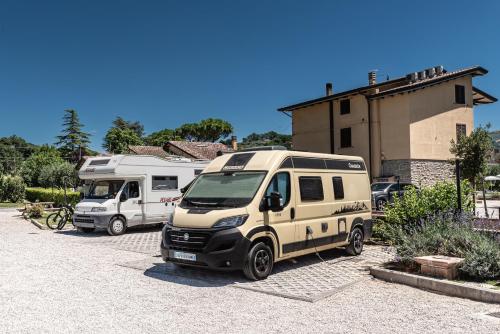 two rvs are parked in a parking lot at Agriturismo Il Girasole Assisi in Assisi