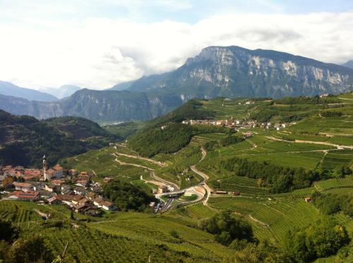 a village in a valley with mountains in the background at Nenez B&B in Giovo