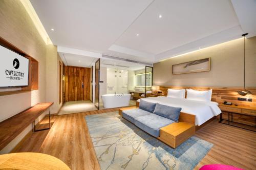 a hotel room with a bed and a bath tub at 杭州忆栖生态艺术酒店西溪湿地店 in Hangzhou