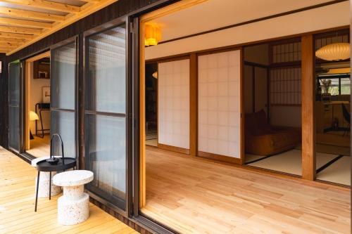 a house with glass doors and a wooden floor at Juju Kiseki House in Naoshima