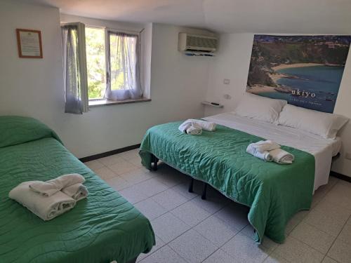 a bedroom with two beds with towels on them at B&B Decarlo Property Tropea in Tropea