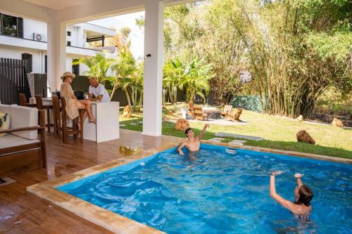 two women in a swimming pool in a house at Heaven Retreat with Minigolf, pool, fire pit, BBQ in Nadi