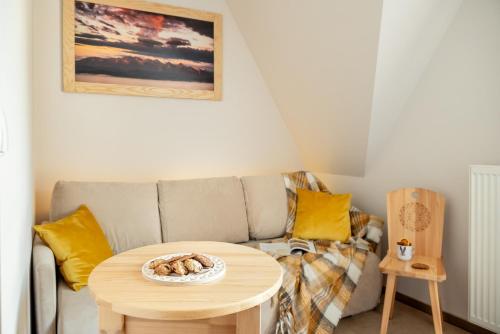a living room with a couch and a table at DW Bogun in Białka Tatrzanska
