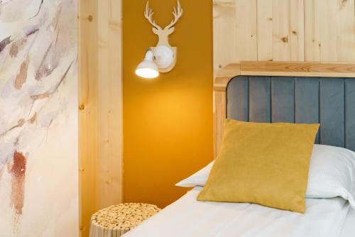a bedroom with a bed with a yellow pillow at DW Bogun in Białka Tatrzanska