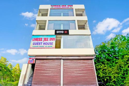 a tall building with a sign that reads guest house at Hotel O Shree Jee Inn Guest House in Gurgaon