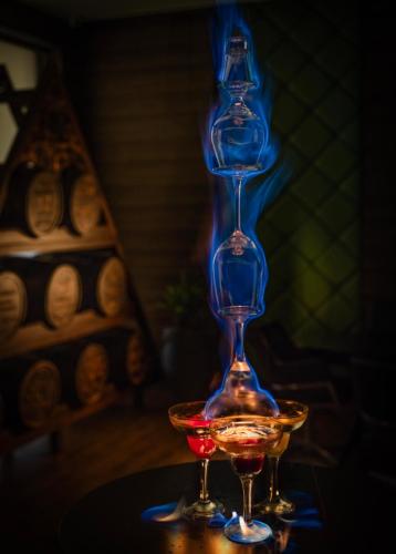 a tall wine glass sitting on a table with two glasses at Distrikt 9 in Palakkad