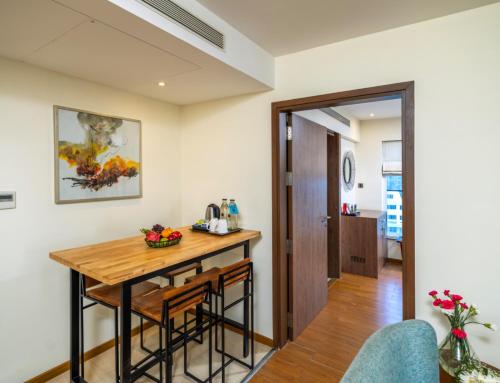 a kitchen with a wooden table in a room at Distrikt 9 in Palakkad