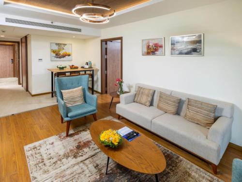 a living room with a couch and a table at Distrikt 9 in Palakkad