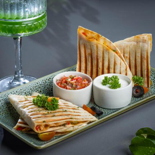 a plate with a sandwich and dip and a glass of wine at Distrikt 9 in Palakkad