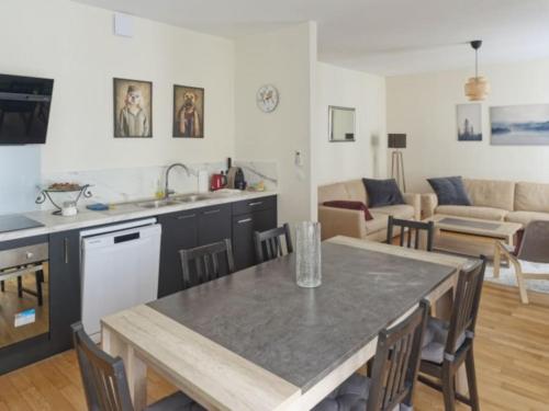 a kitchen and living room with a table and chairs at Appartement spacieux en centre ville in Vendôme