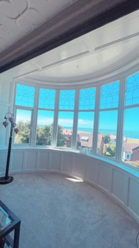 a living room with windows and a view of the ocean at 1 Bedroom Sea side luxury in New Brighton