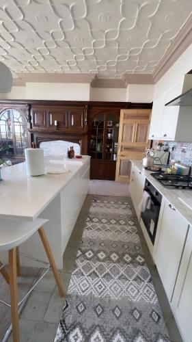 a kitchen with white counters and a white counter top at 1 Bedroom Sea side luxury in New Brighton