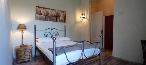 a bedroom with a bed and a lamp on a night stand at Aperando in Tolo