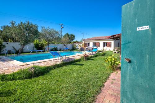 a house with a swimming pool in a yard at Gadem House in Alghero