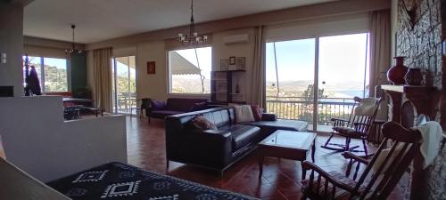 a living room with a couch and a table at Aperando in Tolo