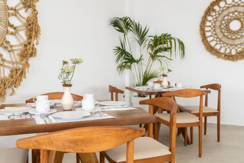 a dining room with wooden tables and chairs at Oniro Skiathos in Skiathos Town