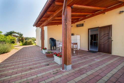 an outdoor patio with a wooden pergola at Gadem House in Alghero