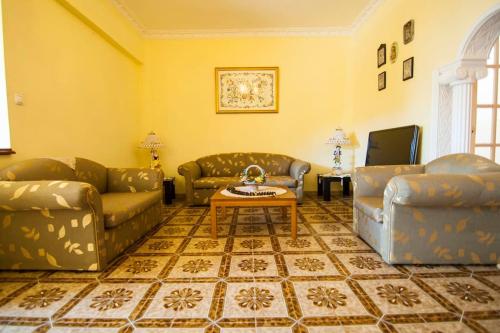 a living room with two couches and a coffee table at sunrayhouse Arkasa in Arkasa