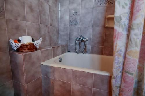 a bathroom with a tub and a shower curtain at sunrayhouse Arkasa in Arkasa