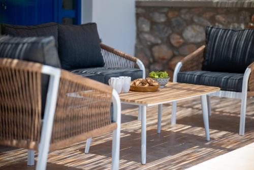 a wooden table with a bowl of fruit on it at Villa Mariani II - in Lothiarika, newly renovated June 2024, private pool, Lindos 10 min, beach 120m in Lardos