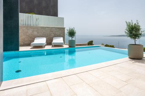 a swimming pool with a view of the water at Villa Brela-Rogac 1 in Baška Voda