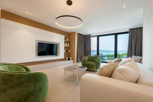 a living room with a couch and two chairs and a tv at Villa Brela-Rogac 1 in Baška Voda