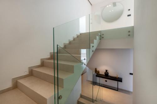 a glass staircase in a house with a table at Villa Brela-Rogac 1 in Baška Voda