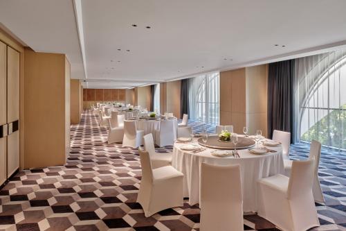 a banquet hall with white tables and white chairs at Hyatt Centric Zhongshan Park Shanghai in Shanghai