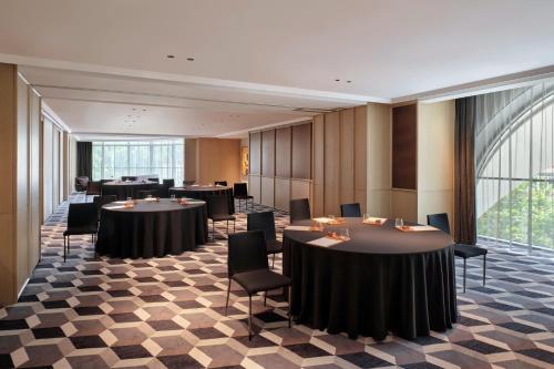a conference room with tables and chairs and a large window at Hyatt Centric Zhongshan Park Shanghai in Shanghai