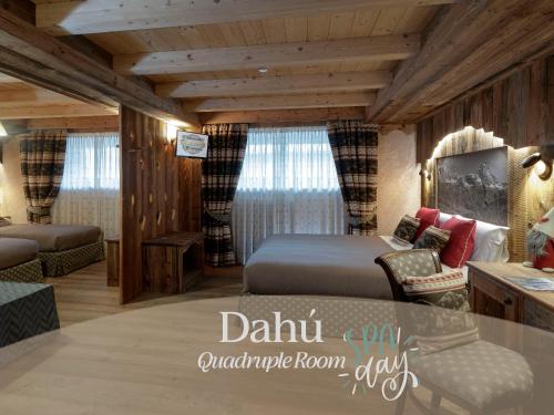 a bedroom with a bed and a couch and a table at Chalet Matterhorn Francois - Central Ski Chalet with SPA and Breakfast, 100mt lift in Breuil-Cervinia