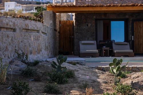 a house with two chairs and a patio at Queen Kalliopi Suites in Plintri
