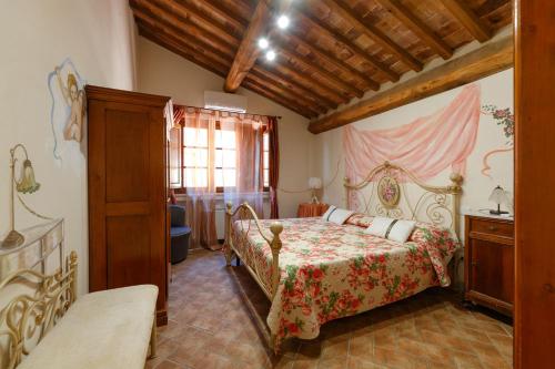 a bedroom with a bed in a room at Borgo Villa Risi in Siena