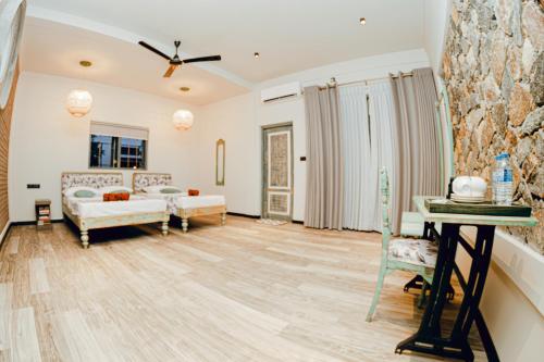 a living room with a couch and a table at Still Waters Artistry in Negombo